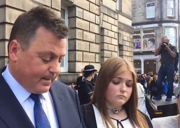 Rebecca Williams with her father, who read a statement on her behalf after Blair Logan was sentenced at the High Court in Edinburgh today (August 11). (Picture: STV)
