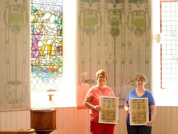 Eunice Cameron and Rhoda Strachan advertise the Big Banner workshop in the church with the panels in the background. Pic by FPA
