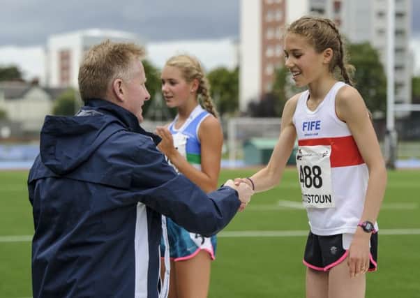 Anna Hedley gets her medal from Scottish Athletics chairman Ian Beattie. Picture by Bobby Gavin.