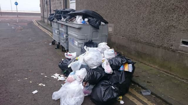 Public asked to report people fly tipping - which includes dumping rubbish alongside existing bins