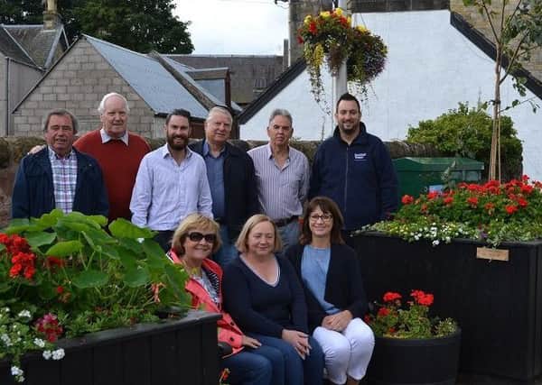 Members of Milnathort in Bloom with representatives of the contractors