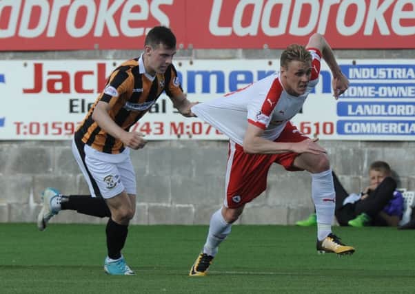 Aaron Dunsmore resorts to illegal tactics in a baid to halt Kevin McHattie. Picture by George McLuskie.