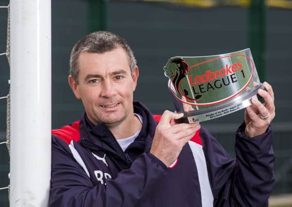 Raith boss Barry Smith with his League One manager of the month award. Pic by SNS.