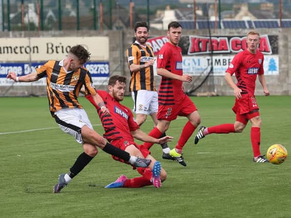 Greg Hurst gets his shot away as East Fife try to break down Queen's. Picture by Dave Scott.