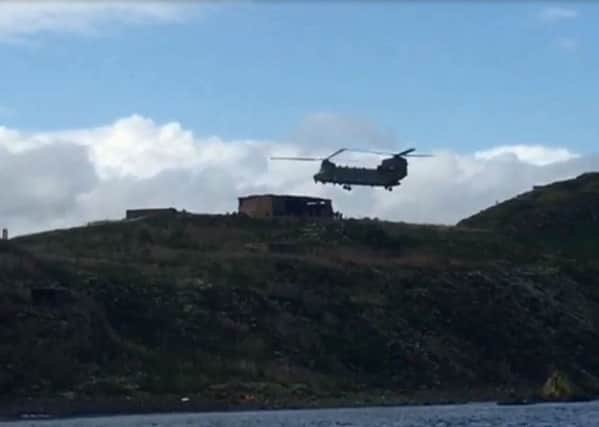 A chinook helicopter landing on Inchkeith Island.