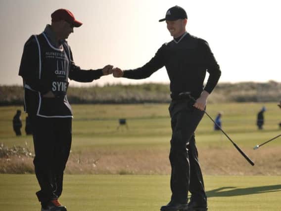 Connor Syme and his caddy Tim Poyser are all smiles after a birdie on the sixth. Picture by John Stewart.