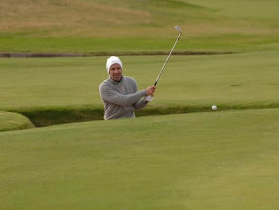 Luis Figo attempts to get out of a bunker during play at the Alfred Dunhill Links Championship. Pic by John Stewart.