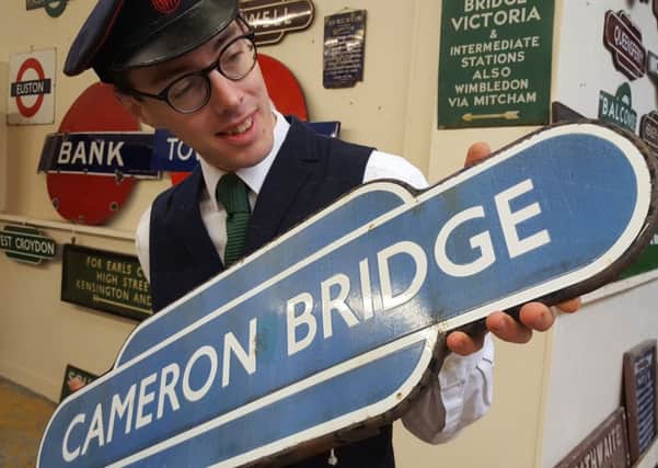 Principal auctioneer Richard Edmonds with the Cameron Bridge sign.