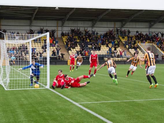 The East Fife fans who remained are rewarded as Greg Hurst powers home a late winner. Picture by Andrew Elder.