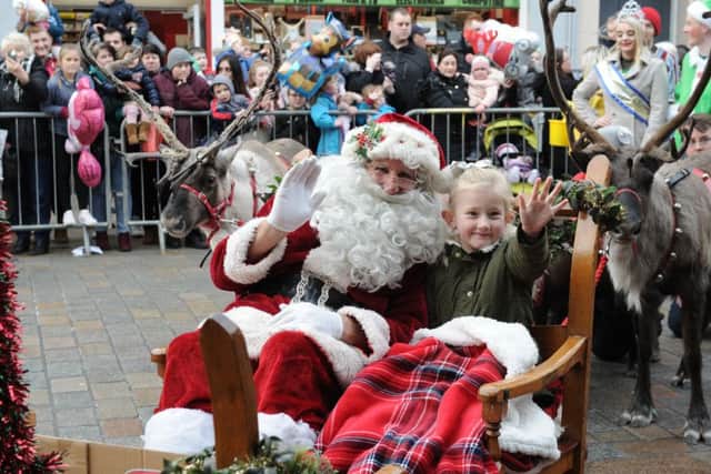 Santa with six year old sleigh ride winner Amy Kennedy from Leven.