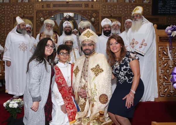 New priest Mikhael Ghattas is pictured with his family  at St Mark's Coptic Church. Pic: David Cruickshanks.