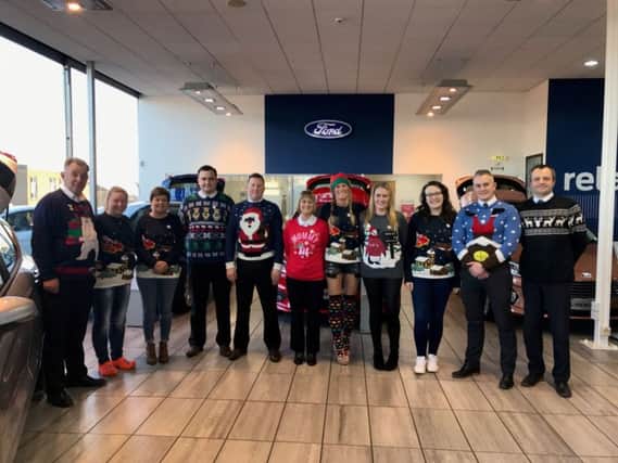 The team at Evans Halshaw Ford Kirkcaldy show off their festive jumpers.