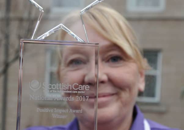 Dementia care nurse Nina Hutchinson with her award. (Pic George McLuskie).