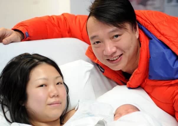 Mum Fung Sze Kwok with baby Aidan, weighing 7lbs and 10oz, and Dad Louis Cheuk from Glenrothes. Pic credit: WALTER NEILSON