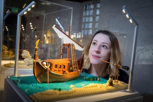 A member of HES staff with one of the models on display at Aberdour Castle.