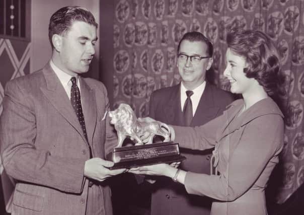 Douglas Adams is presented with one of his Lion Awards.