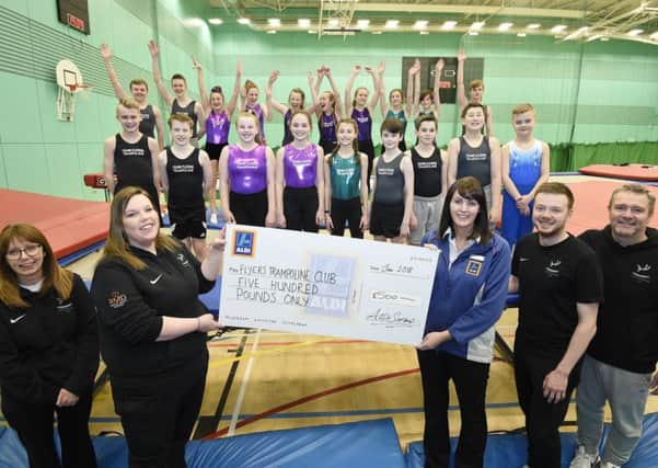 Glenrothes Store Manager Fiona Forrester presents a cheque for Â£500 to Flyers Trampoline Club at the Michael Woods Centre in Glenrothes , picture: Greg Macvean