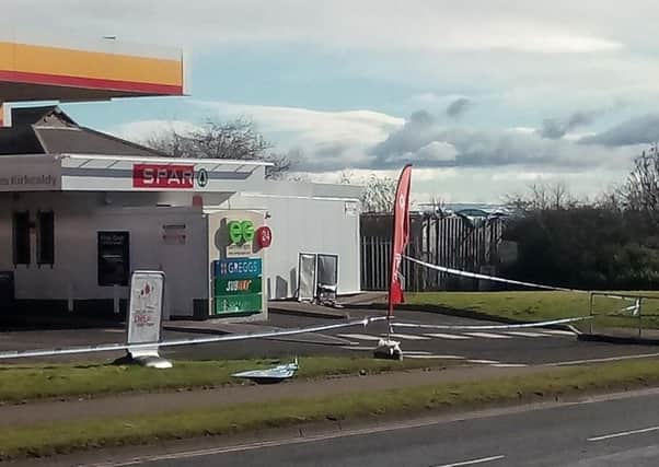 Police sealed off the Shell garage on Hendry Road.