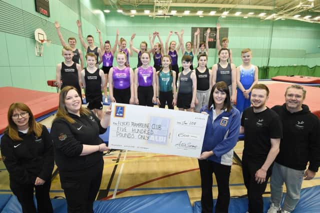 Aldi Glenrothes Store Manager Fiona Forrester presents a cheque for Â£500 to Flyers Trampoline Club at the Michael Woods Centre in Glenrothes. Pic: Greg Macvean