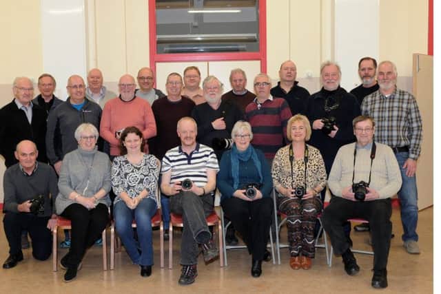Kirkcaldy Photographic Society's 120th anniversary. He is looking for a group photo of the current members. pictured is Club President Martin Watt. with fellow Photographers.