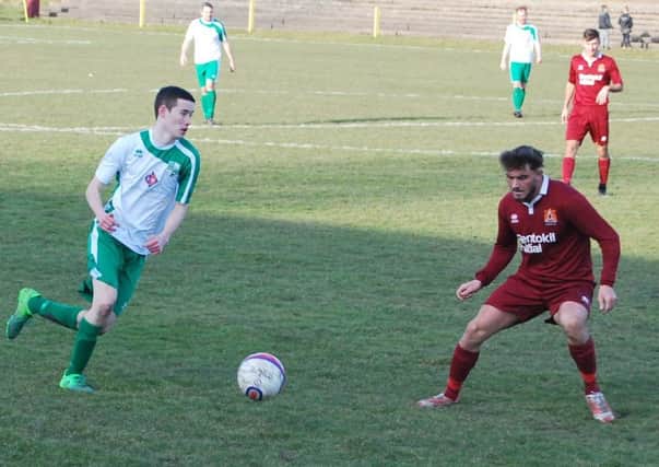 Matthew Robertson of Thornton Hibs takes on Liam McIntosh of Arniston Rangers in their 0-0 stalemate