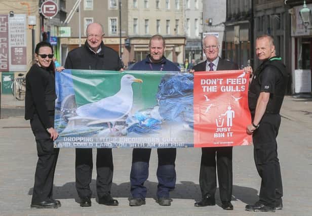 From left: Catriona Linton, Safer Communities officer; Cllr Neil Crooks; Robert Lowrie, pest control officer; Cllr Vettraino and Ian Wilson, Safer Communities officer, with one of the new banners.