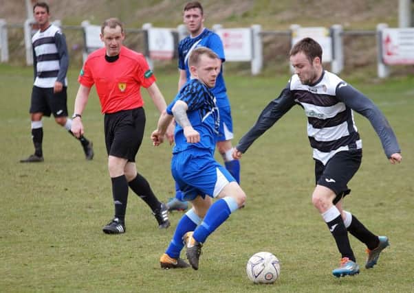 Ryan McInnes looks to win the ball back for Saints. Picture by George Wallace