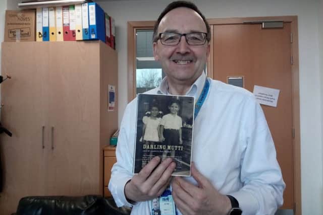 Adrian Watt, current rector of Viewforth High School with a copy of Dear Mutti which tells the story of Edith's arrival in the UK