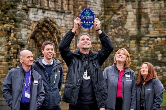 Richard Falconer from St Andrews Ghost Tours, centre, receives his award from VisitScotland's strategic partnership executive, Neil Christison, and St Andrews iCentre staff, from left, Colin McKilop, Heather Holanek and Nicola Harrison.

Photographer
Fraser Band