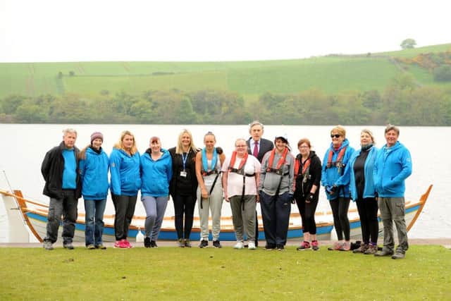 Gordon Brown, honorary patron and Gillian Downs, family worker with the Cottage with the women who are taking part in the project and members of the rowing club.