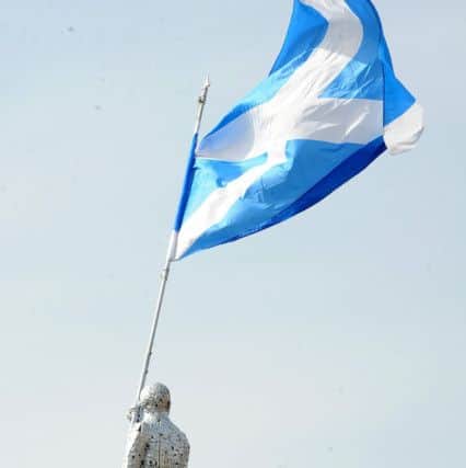 The Flag Bearer stands on the roof of Archway Metals in Kinghorn. Pic: Fife Photo Agency.