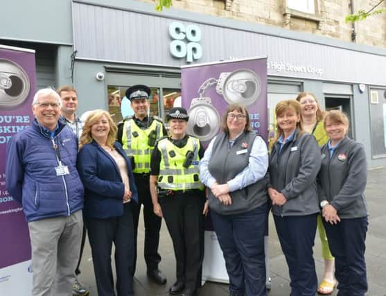 PC Liz James with sergeant Jimmy Adamson, Cllr Carol Lindsay, local councillors Gordon Langlands and Lesley Backhouse, Carole Anne Crossan, Sharon Gibson and Debbie Hunter from the Co-op. Pic by George McLuskie.