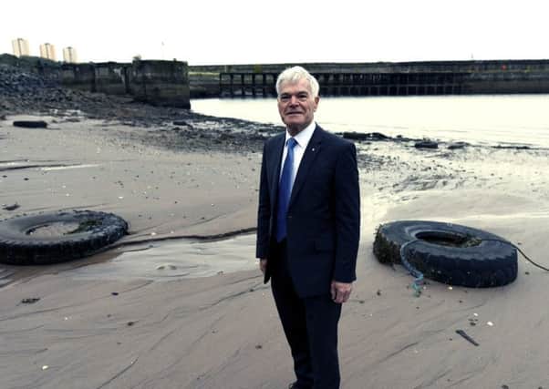 Kirkcaldy councillor Rod Cavanagh, himself a resident at Deas Wharf, pictured with the beached tyres in October last year.