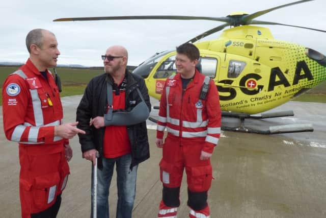 Jason Dale (47) with SCAA paramedics John Pritchard (left) and Graeme Hay.