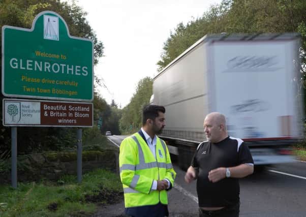 Robert Brown with Scottish Transport Minister Humza Yousaf closs to the site where nine-year-old Logan Carrie was killed.