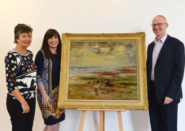Carnoustie Bay comes to Kirkcaldy Galleries in significant new McTaggart donation. From left: Claire Hunter Chow, who  donated the painting; Heather Stuart, chief executive, Fife Cultural Trust and Gavin Grant, Fife Cultural Trust. Pic: George McLuskie.