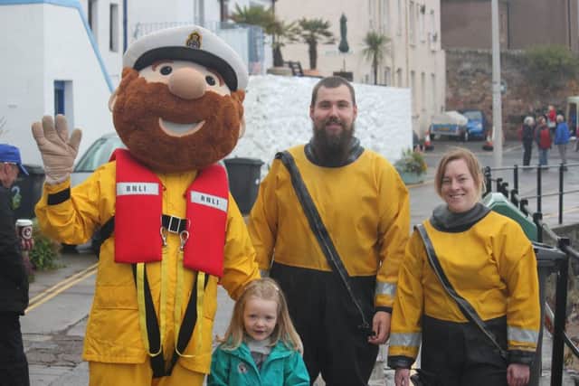 Stormy Stan the lifeboat's mascot with Theresa Davies, daughter of crew member Dean Davies, and former crew member Suzanne Baillie.