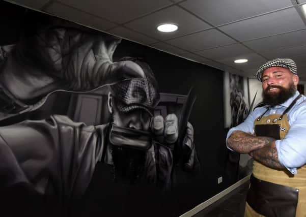 Revolution Barbershop owner Mark Reynolds with the new wall mural by Spanish artist Murales Lian (Pics by Fife Photo Agency)