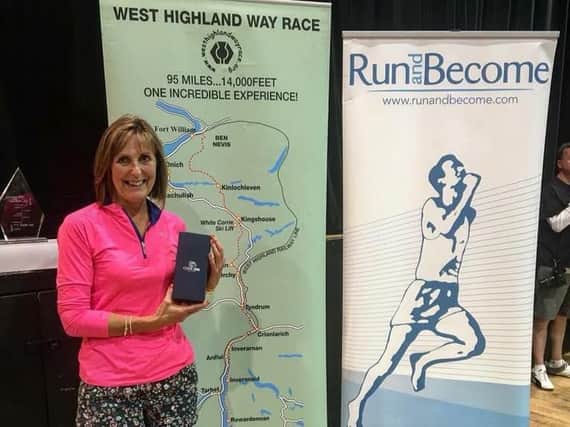 Carole Mowbray with her prize for 1st over-50 at the West Highland Way race (picture: Gordon Donnachie)