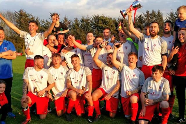 Kirkcaldy YM AFC celebrate winning the KAFA Championship Cup final, the match which featured Jordan Hutchison's Goal of the Month strike.