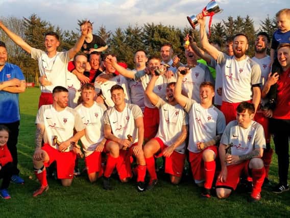 Kirkcaldy YM AFC celebrate winning the KAFA Championship Cup final, the match which featured Jordan Hutchison's Goal of the Month strike.