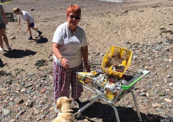 Eunice Cameron with a trolley full of rubbish left on Ravenscraig Beach after the weekend