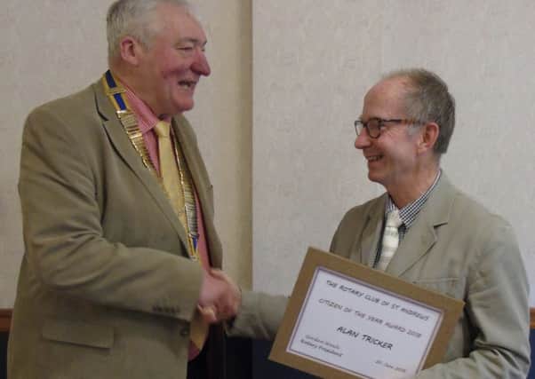 Club president Gordon Wowk presents the Non-Rotarian Citizen of the Year Award to Alan Tricker.