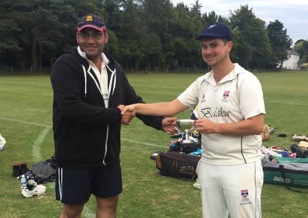 St Andrews captain, James Crooks, receiving the Ferrier Cup from Dundee captain, Hamza Khan.