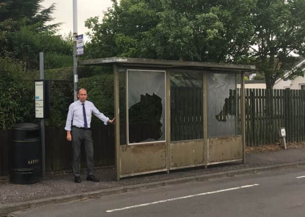 Cllr Thomson at the bus shelter.