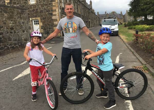 Mark Edgcumbe with children Emily (7) and  Liam (9) at Greenside, Leslie - highlighting the increasing number of motorists driving the wrong way up a one-way system at the Greenside - puting his youngsters at risk following several near misses with local residents.