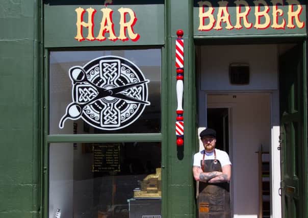 Owner David Logue outside the barbers.