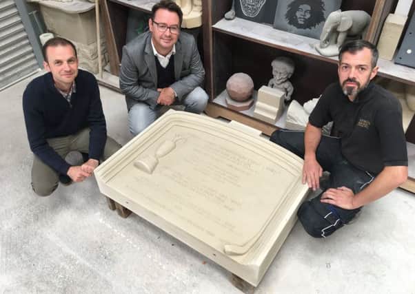The headstone for Jamie Anderson. Pictured, from left, MP Stephen Gethins, Roger McStravick, and sculptor Mark Ritchie.