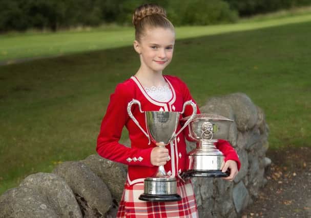 Murron proudly displaying her trophies from her championship wins.