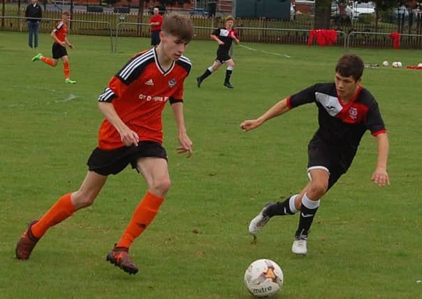 Thornton Hibs Under 19s Ryan O'Donnell taking on Euan Brand of Scone Thistle Under 19s